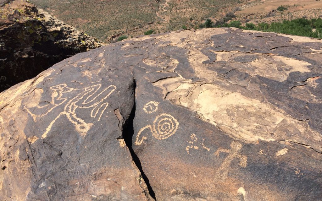 boulder with multiple designs vista in back