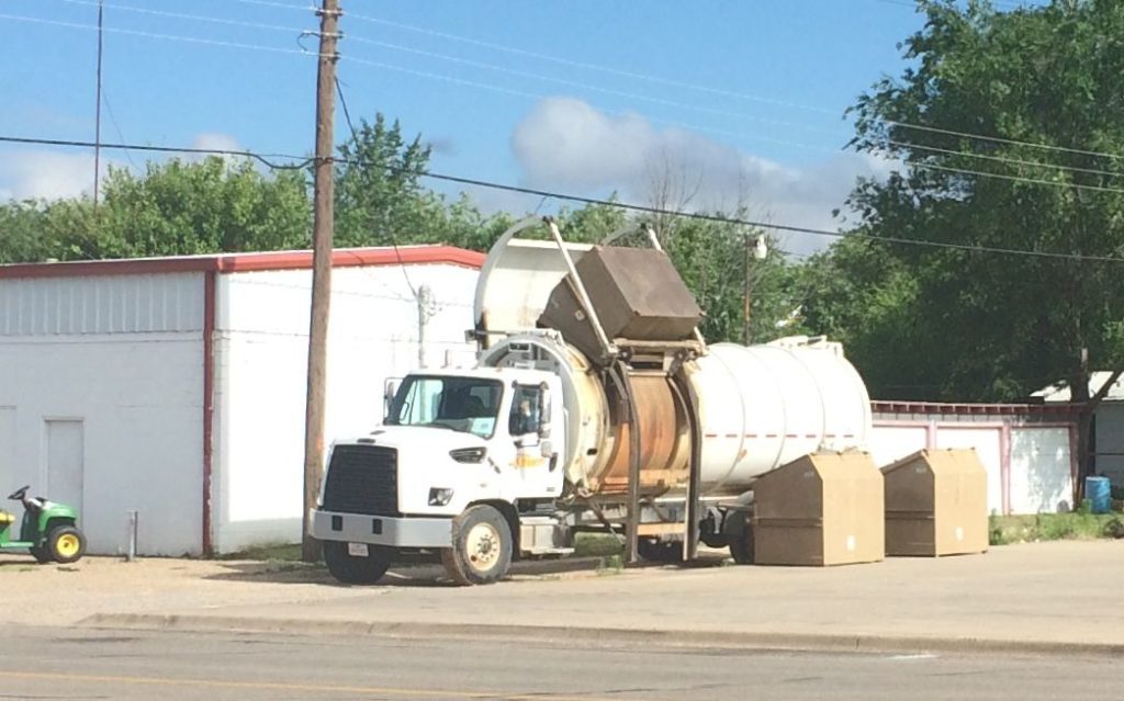 cylindrical trash truck dumping