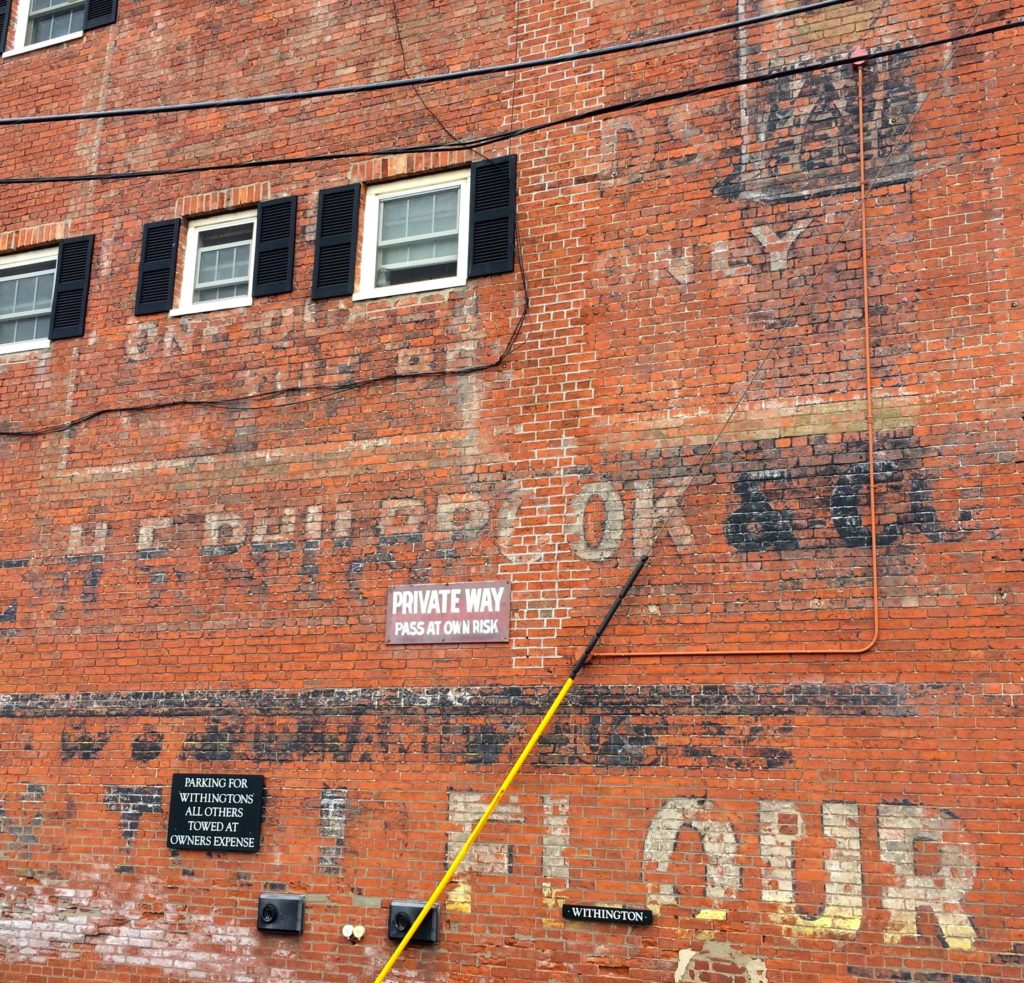sign-painted-on-brick-wall